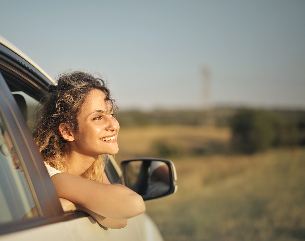 Mujer asomándose del auto